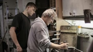 Master wealder showing apprentice how to handle detailing