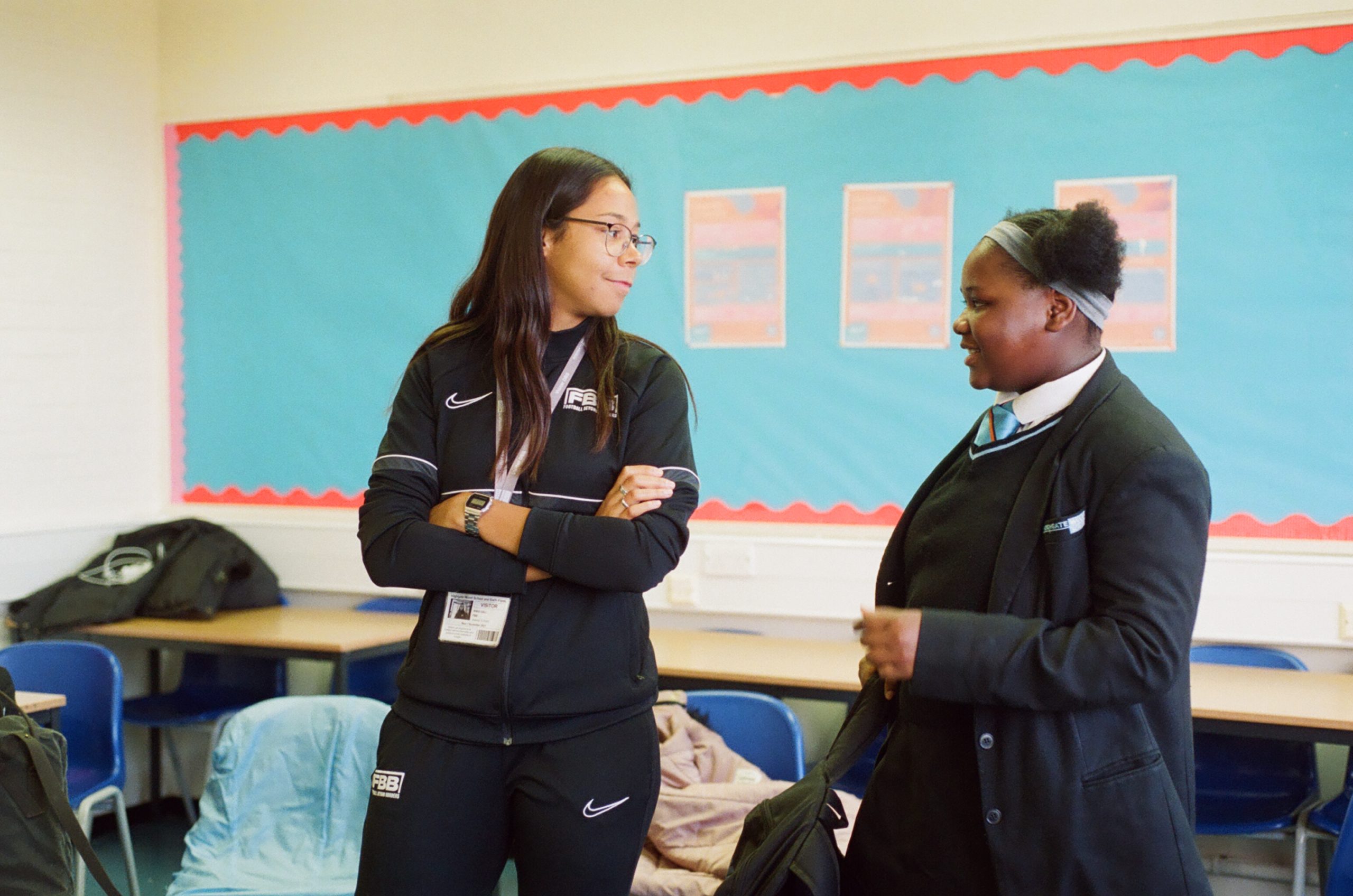 A student and their mentor in a classroom